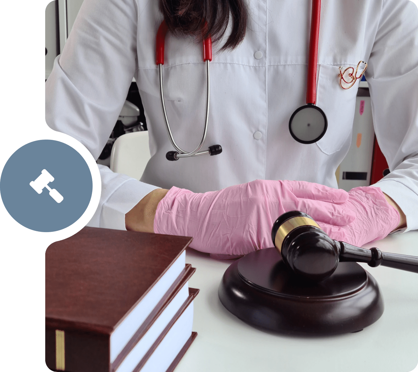 A doctor is holding the gavel on top of a table.